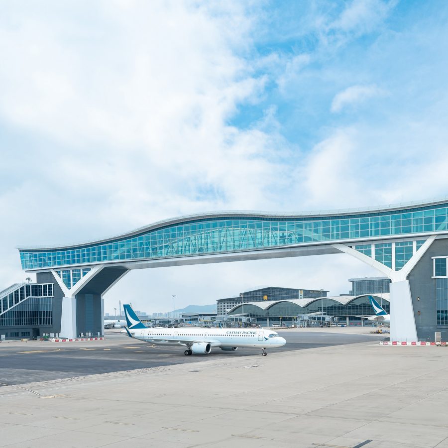  A view of Hong Kong International Airport’s skybridge with a Cathay Pacific airport crossing on a clear day.